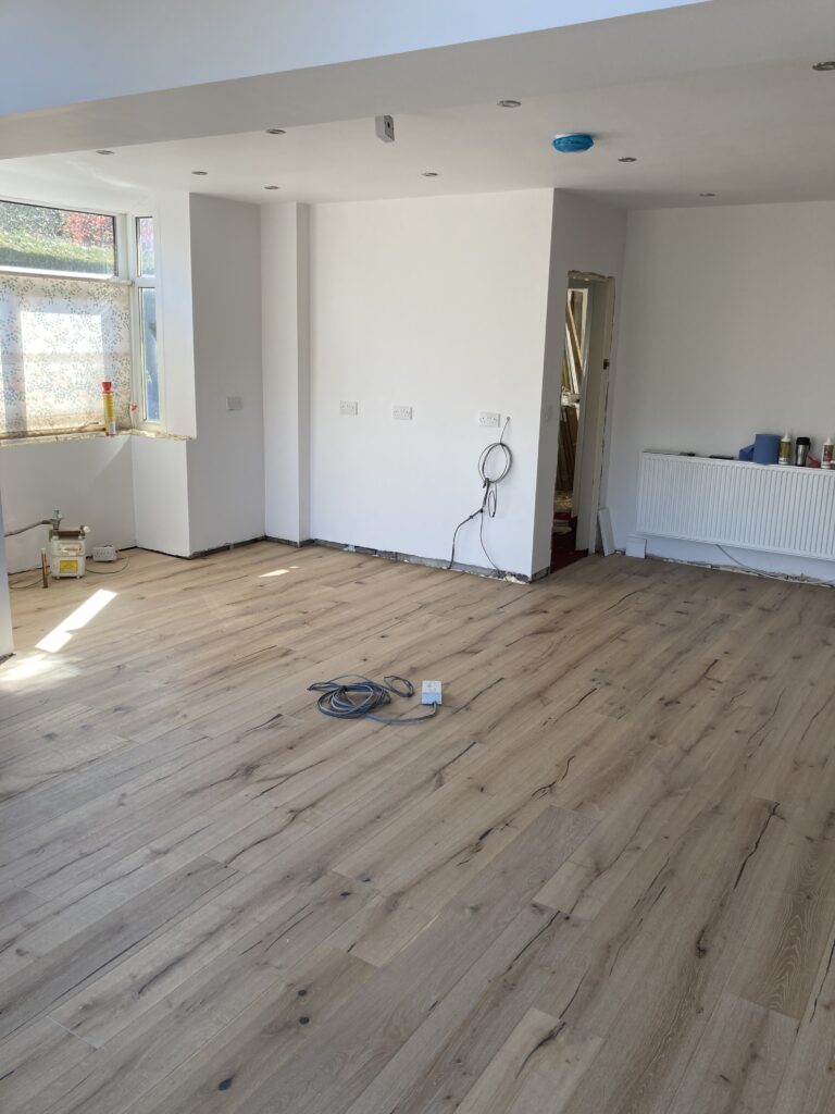 New solid wood flooring laid through the open-plan kitchen and dining room
